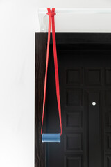 The elastic rubber band on a metal pull-up bar with fat grip handle