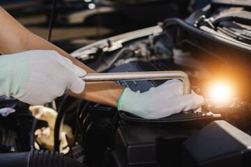 Repairman mechanic fixing a car with a socket wrench