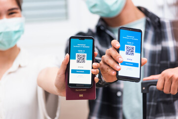 couple woman and man ready to travel showing digital vaccine health passport certificate app in smartphone