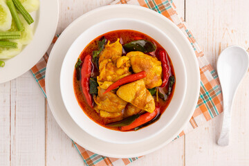 Flat lay chicken curry with southern Thai curry paste and holy basil leaves. This simple savory Thai food dish is delicious and pairs well with steamed rice and fresh vegetable.