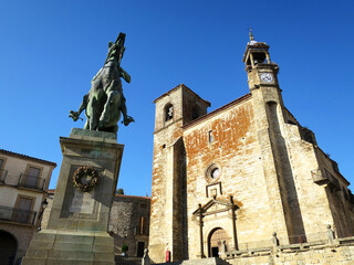 Fototapeta na wymiar The Francisco Pizarro Statue and San Martin Church at the Main Square (Plaza Mayor) in Trujillo, SPAIN
