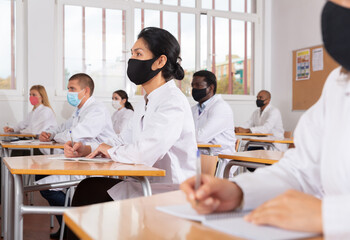 Group of medical academy students in protective masks at the lesson