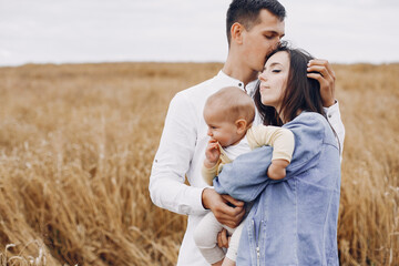 Cute family playing in a autumn field