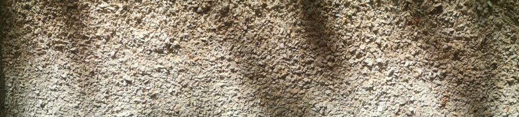 Naklejka premium Close-up Small concrete pebble texture with rock background abstract cement mixed with stone texture, panoramic background.