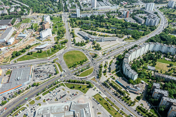 urban roundabout junction with traffic of cars on sunny summer day. city infrastructure. aerial view from flying drone