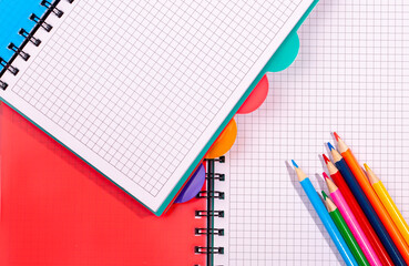 colored notebooks and pencils. Pencils on an empty notebook