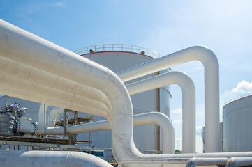 Oil pipeline and Oil storage tank farm in the petroleum refinery.Above ground storage tanks can be...