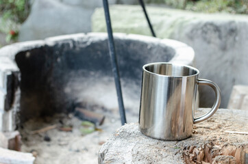 metal cup background of Heap firewood stack, natural wood and firebox