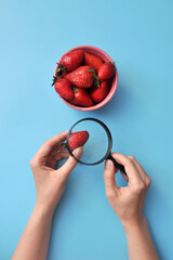 a person checks the quality of food with a magnifying glass