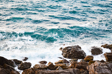 Blue sea  with waves and foam and rock