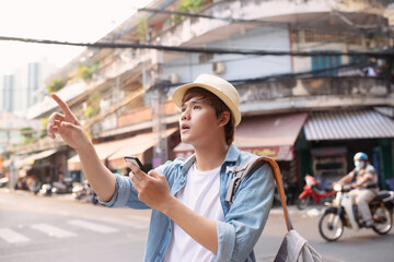 Young man hipster traveling with backpack and hat,