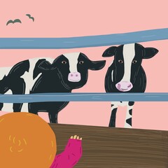 Child points at curious cows who are standing in a pen