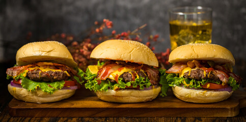 Selective focus on hamburgers with beef burgers, fried onions, spinach, ketchup and cheese. Served...