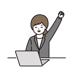 パソコンの前でガッツポーズをするビジネスウーマン