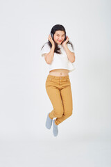 woman with headphones and jumping on  background