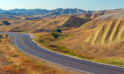 Yellow Mounds with highway in summer, Badlands national park, South Dakota, USA. - obrazy, fototapety, plakaty