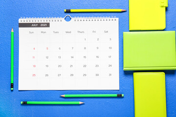 Flip paper calendar and stationery on color background