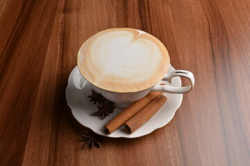 hot masala chai latte drink with cinnamon and star anise in beautiful England design white cup hot coffee beverage menu