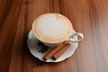 hot masala chai latte drink with cinnamon and star anise in beautiful England design white cup hot coffee beverage menu