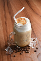 ice cafe mocha latte drink with bubbles and coffee bean in glass on wood table coffee beverage menu 