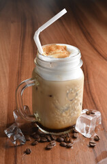 ice cafe mocha latte drink with bubbles and coffee bean in glass on wood table coffee beverage menu