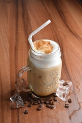 ice cafe mocha latte drink with bubbles and coffee bean in glass on wood table coffee beverage menu