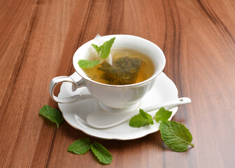hot moroccan mint leaf tea bag drink in beautiful England design white cup hot healthy beverage menu
