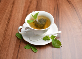 hot moroccan mint leaf tea bag drink in beautiful England design white cup hot healthy beverage menu