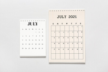 Flip paper calendars on light background