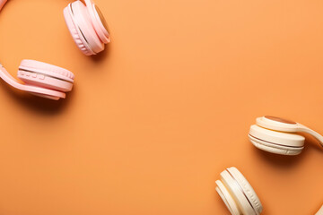 Modern headphones on color background