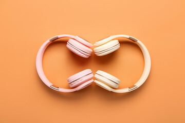 Modern headphones on color background