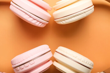Modern headphones on color background, closeup