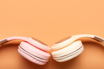 Modern headphones on color background, closeup