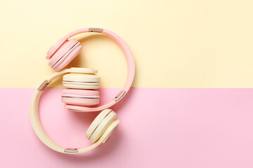 Modern headphones on color background