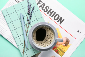 Composition with newspaper and cup of coffee on color background