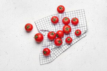 Fototapeta na wymiar Fresh ripe tomatoes and napkin on light background