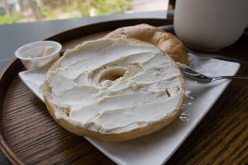 a plate of Bagel with Cream Cheese and Coffee.