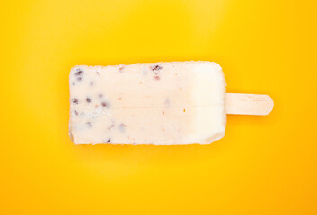 top view fresh milkshake flavor popsicle with red beans on a yellow background