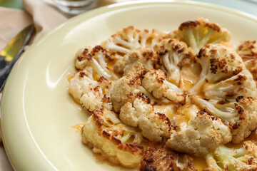 Plate with tasty fried cauliflower and cheese, closeup