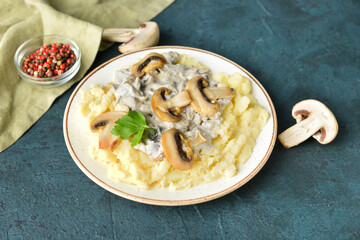 Plate with tasty mashed potatoes, mushrooms and peppercorns on color background
