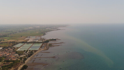 aerial tropical landscape coastline town by sea, beach, boats on surface water. Bali,Indonesia, travel concept.