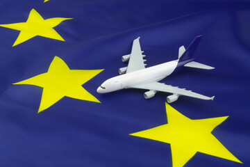 Airplane model on European Union flag. Travel and transportation in EU concept.