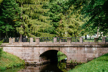 Landscape with an old bridge made of large blocks of rough stone.