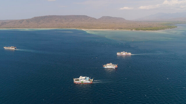 public ferry ships carrying passengers from Gilimanuk harbour ferry port in Bali Island to Ketapang harbour East Java, Indonesia