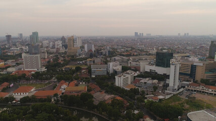 Aerial cityscape modern city Surabaya with skyscrapers, buildings and houses. sunset in city skyline with skyscrapers and business centers Surabaya capital city east java, indonesia