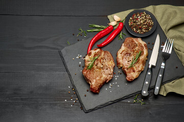 Grilled roated beef steaks on stone serving cutting board