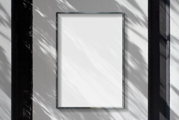 Metal frame hanging in street mockup. Template of a picture framed on a wall bathed in sunlight 3D rendering
