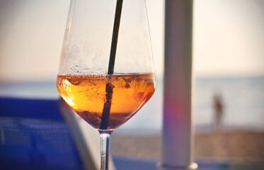 Close up of a cold cocktail drink at the beach. Concept of vacation and summer time.