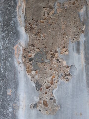 gray paint peeled off gravel mixed concrete texture.