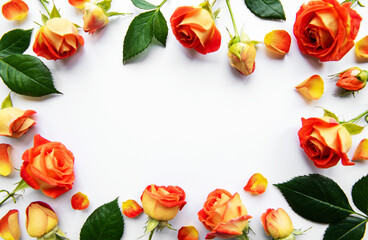 Flowers composition. Frame made of red  roses and leaves on white background